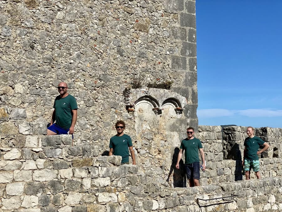 The team outside a set of castle ruins